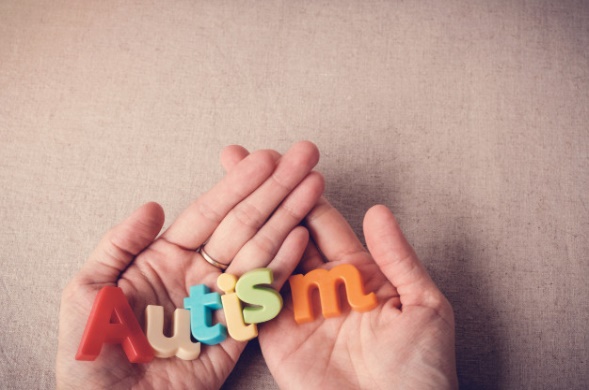 Autism colorful word on hands, wolrd autism day, april autism awareness month Premium Photo